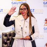 Woman speaking at Gauteng government event.