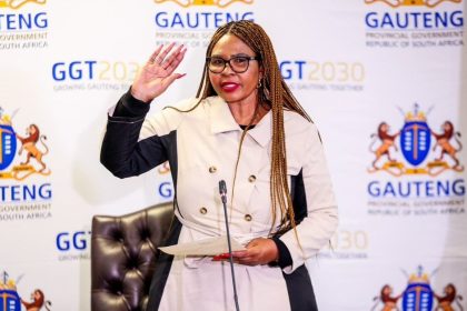 Woman speaking at Gauteng government event.