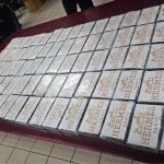 Seized Hermes-branded packages stacked on a table.