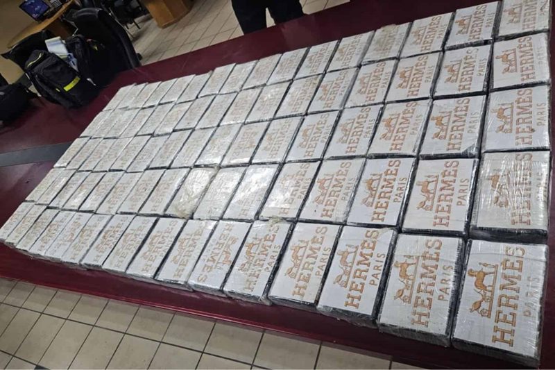 Seized Hermes-branded packages stacked on a table.