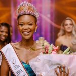 Miss South Africa winner with crown and flowers.