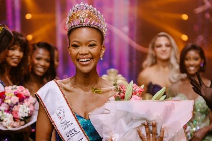 Miss South Africa winner with crown and flowers.