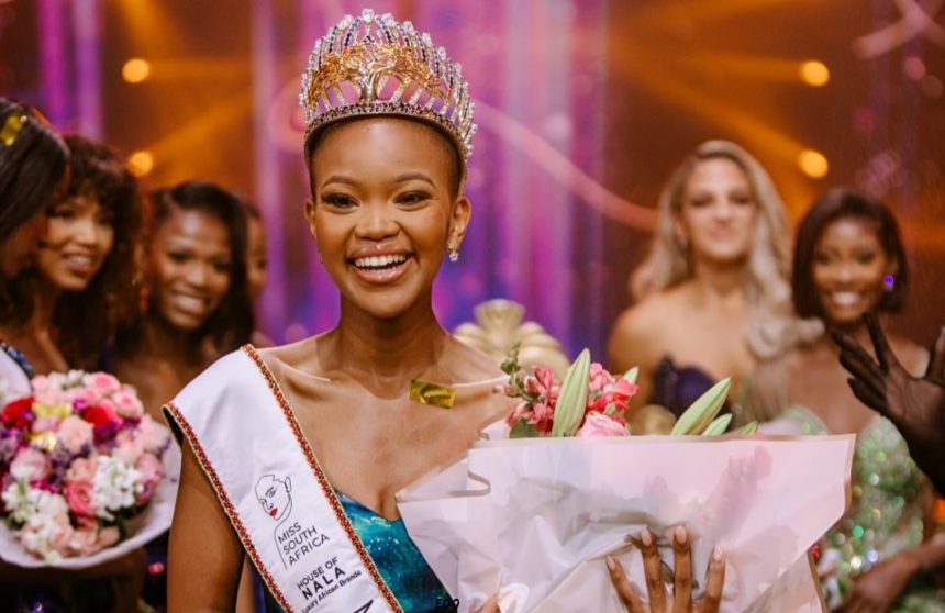 Miss South Africa winner with crown and flowers.
