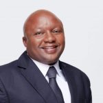Smiling man in a suit and tie portrait.