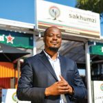 Person in front of Sakhumzi Restaurant, Soweto.