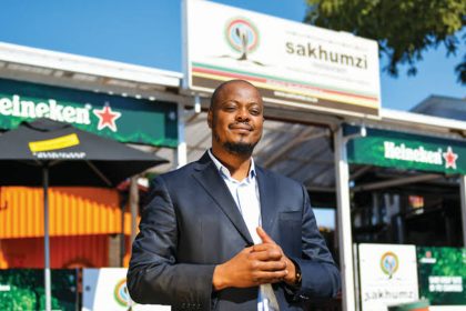 Person in front of Sakhumzi Restaurant, Soweto.