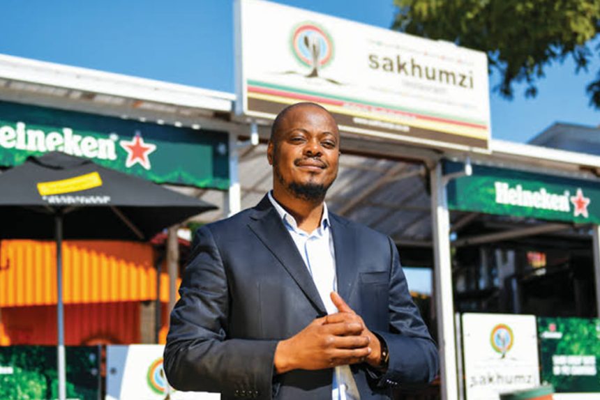 Person in front of Sakhumzi Restaurant, Soweto.