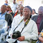 Elders seated at a cultural event.