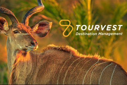 Kudu in sunset, Tourvest Destination Management logo visible.