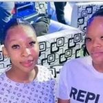 Two people smiling in a colourful room.