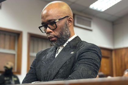 Man in courtroom thoughtful and serious expression.