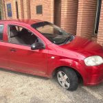 Red car with flat front tyre parked