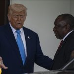 Two leaders meeting, discussing outside a building.