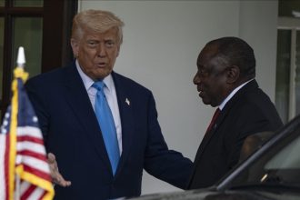 Two leaders meeting, discussing outside a building.