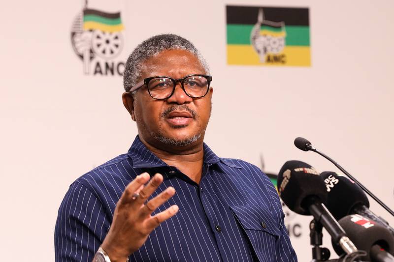 Man speaking at ANC conference with microphones