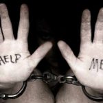 Hands in chains with 'Help Me' message.
