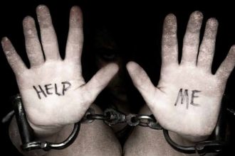 Hands in chains with 'Help Me' message.