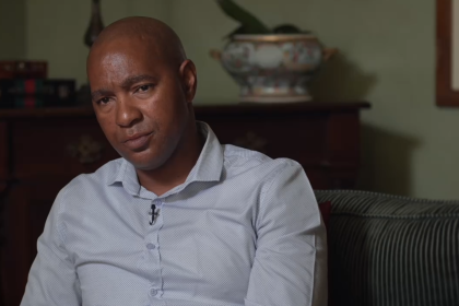 Luyanda Mboniswa sitting on a couch, looking thoughtful.