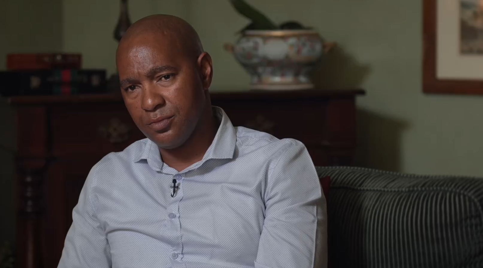 Luyanda Mboniswa sitting on a couch, looking thoughtful.