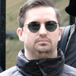 Matthew Gruter wearing sunglasses and black jacket outdoors.