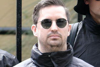 Matthew Gruter wearing sunglasses and black jacket outdoors.