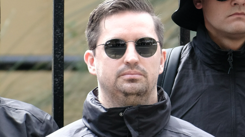 Matthew Gruter wearing sunglasses and black jacket outdoors.