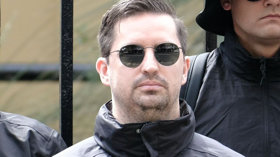 Matthew Gruter wearing sunglasses and black jacket outdoors.