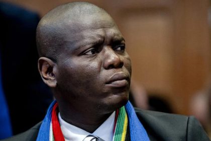 Person in formal attire with colourful scarf.