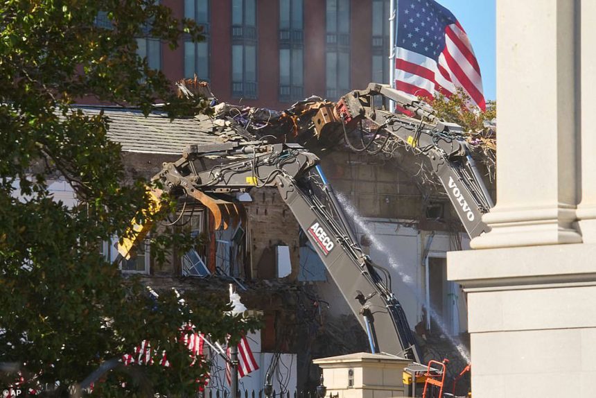 Demolition of building with excavators in progress.
