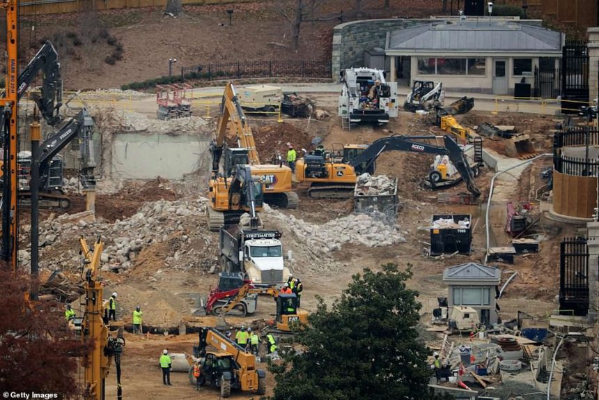 Construction site with heavy machinery and workers.