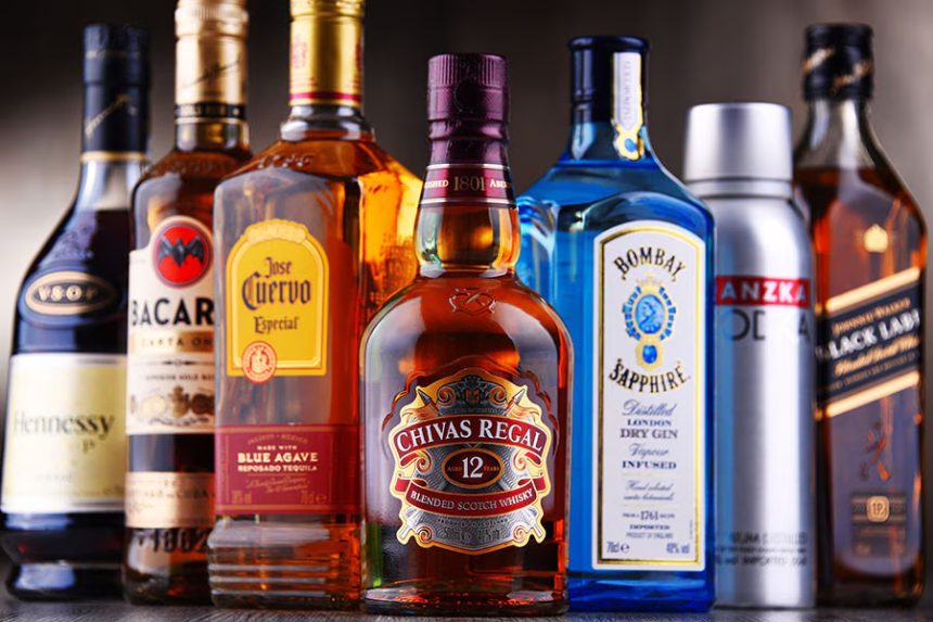 Assorted liquor bottles on a bar counter