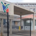 Ekurhuleni City entrance with logo and building view.