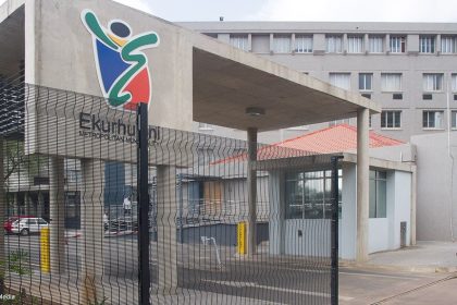 Ekurhuleni City entrance with logo and building view.