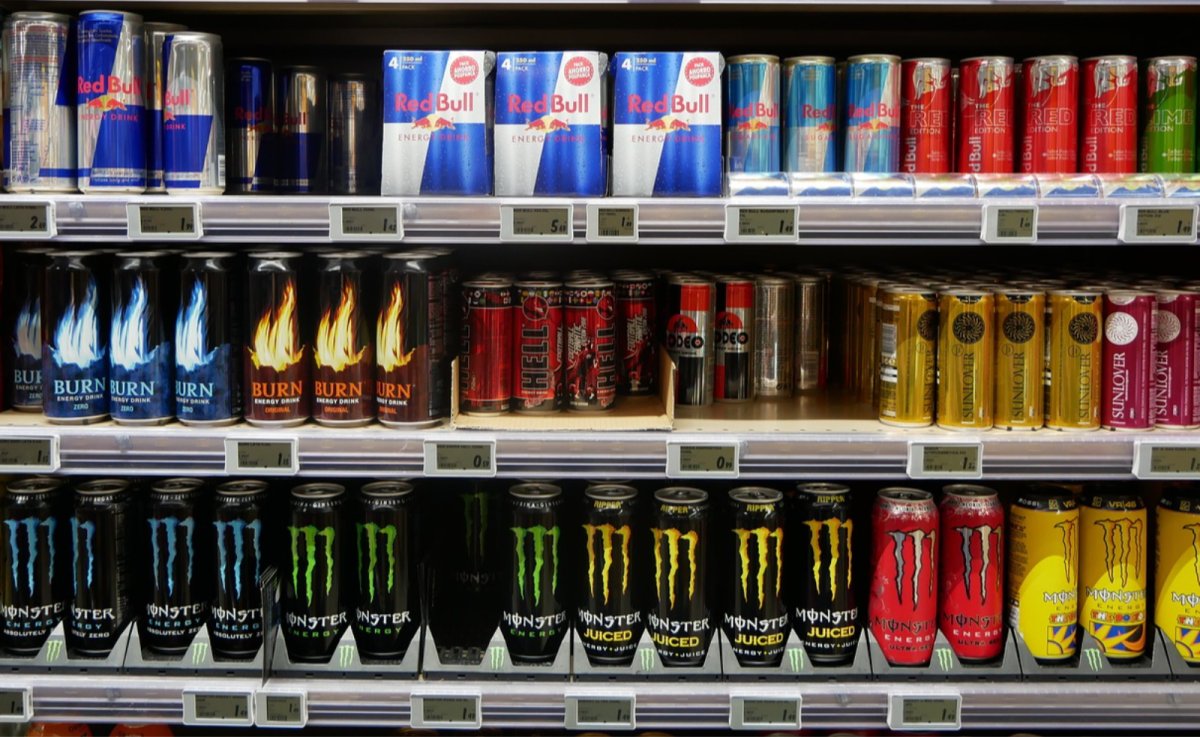 Assorted energy drinks displayed on supermarket shelves