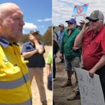 Protesters with signs in a rural area.