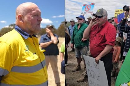 Protesters with signs in a rural area.