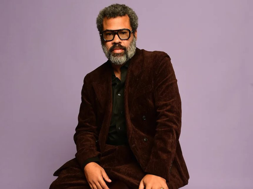 Man in brown suit posing against purple background