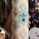 Maxhosa Lifestyle patterned flask held in hand