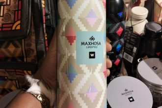 Maxhosa Lifestyle patterned flask held in hand