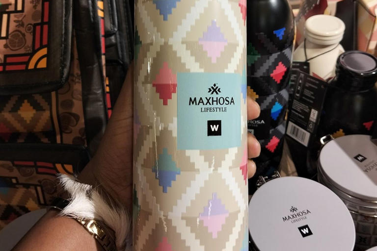 Maxhosa Lifestyle patterned flask held in hand