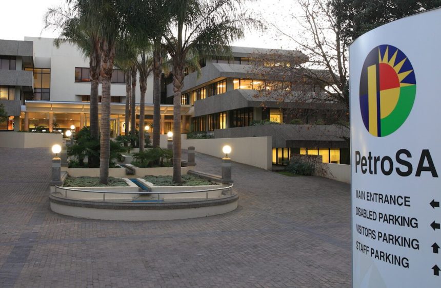 PetroSA headquarters entrance with signage and palm trees.
