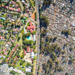 Aerial view contrasting affluent and informal settlements in Johannesburg.