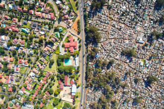 Aerial view contrasting affluent and informal settlements in Johannesburg.