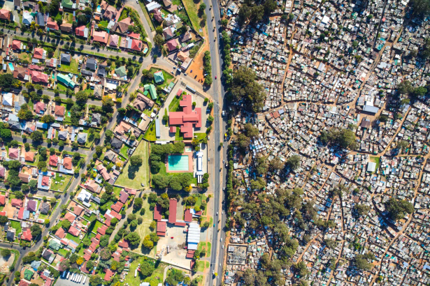 Aerial view contrasting affluent and informal settlements in Johannesburg.