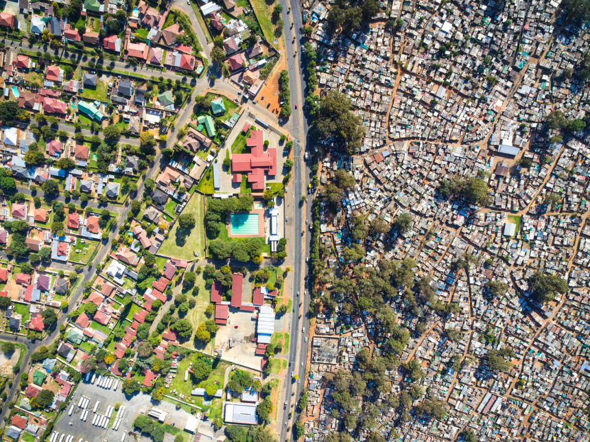 Aerial view contrasting affluent and informal settlements in Johannesburg.