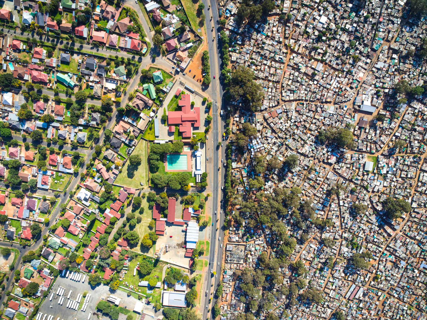 Aerial view contrasting affluent and informal settlements in Johannesburg.