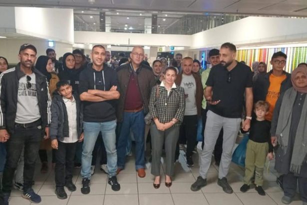 Group of people gathered at airport terminal.