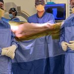 Surgeons preparing for a medical procedure in theatre.