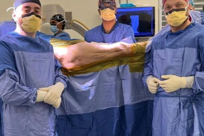 Surgeons preparing for a medical procedure in theatre.