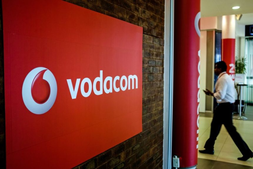 Vodacom logo on brick wall in office lobby.